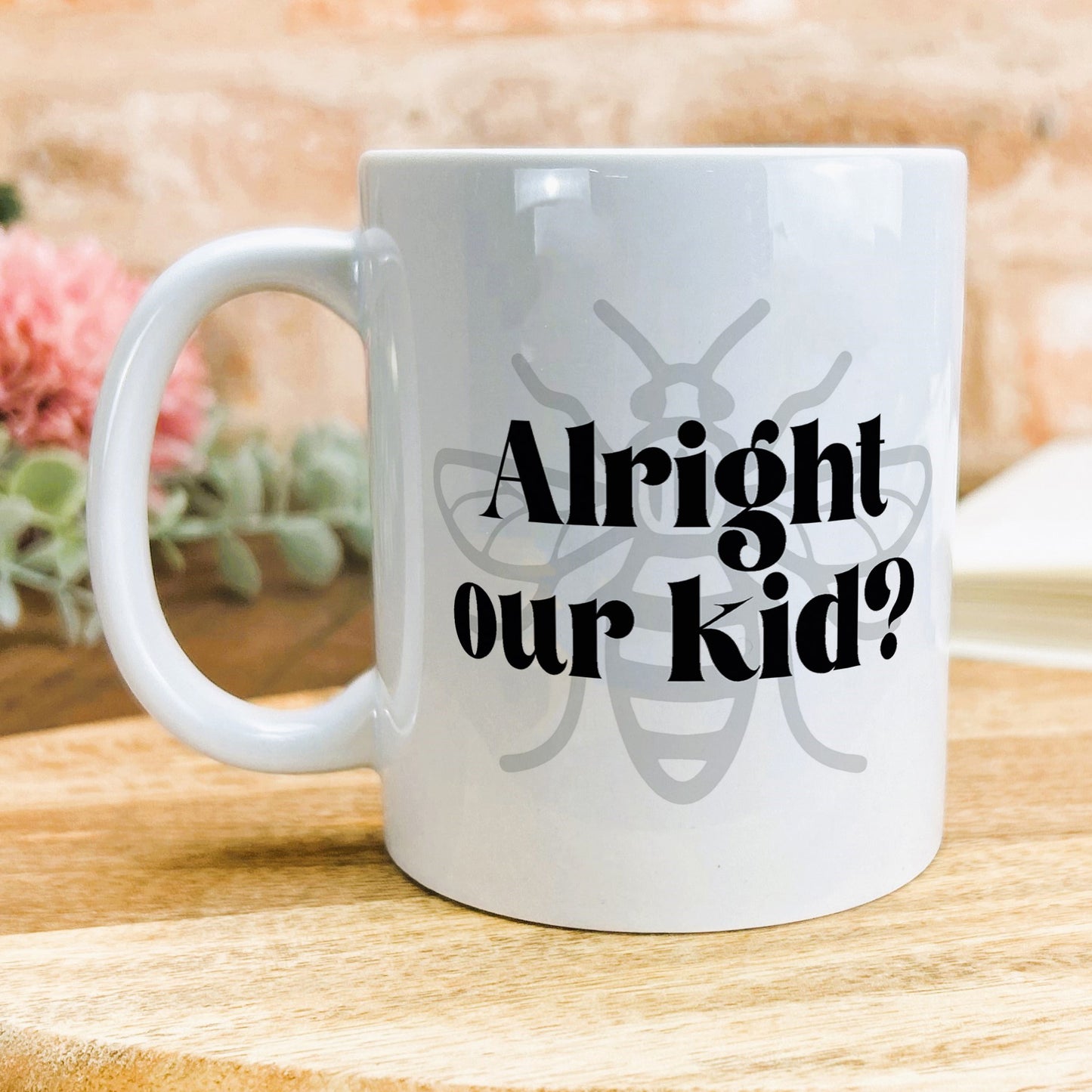 a white coffee mug sitting on top of a wooden table