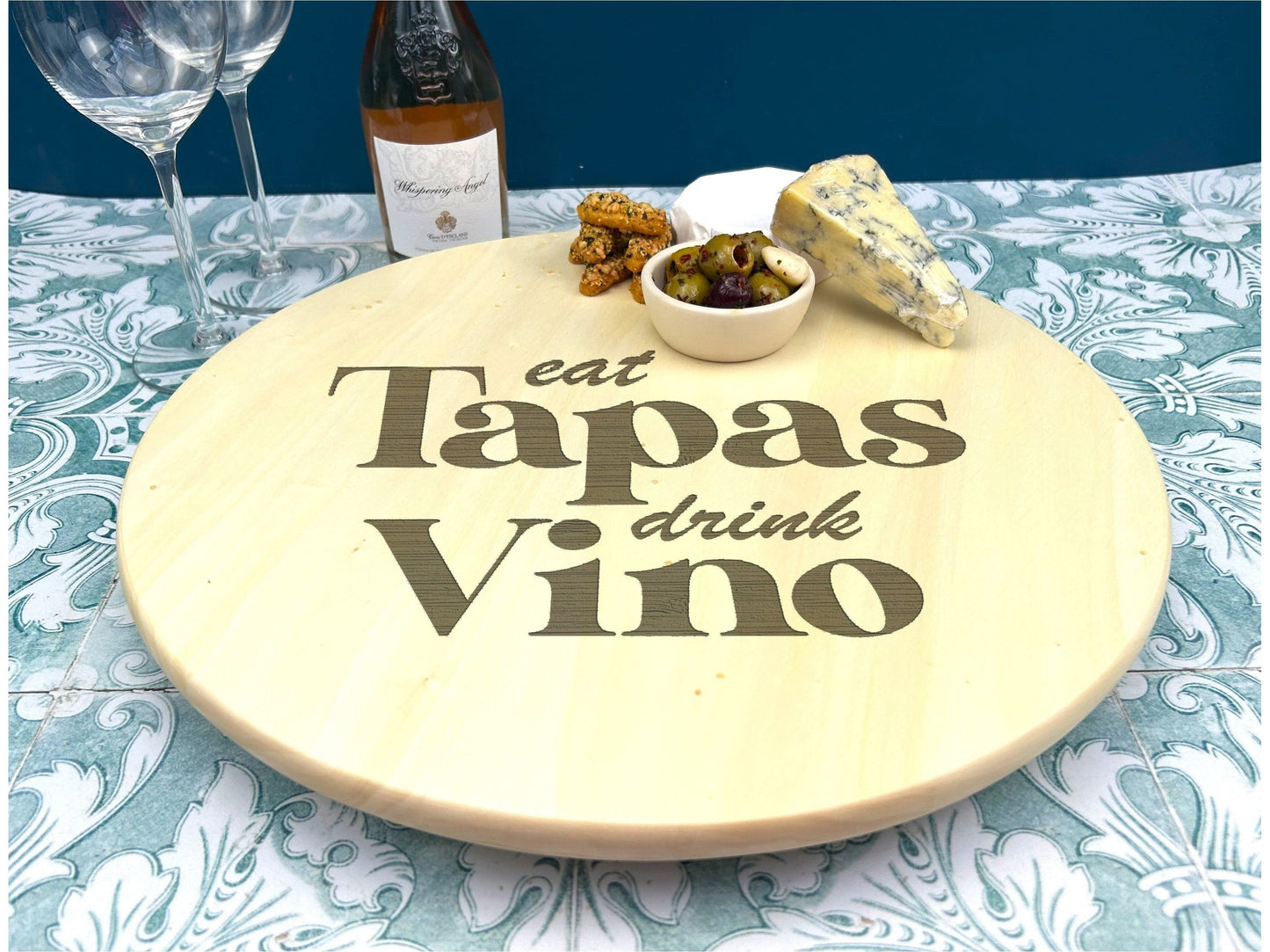 a table with a plate of food and a bottle of wine