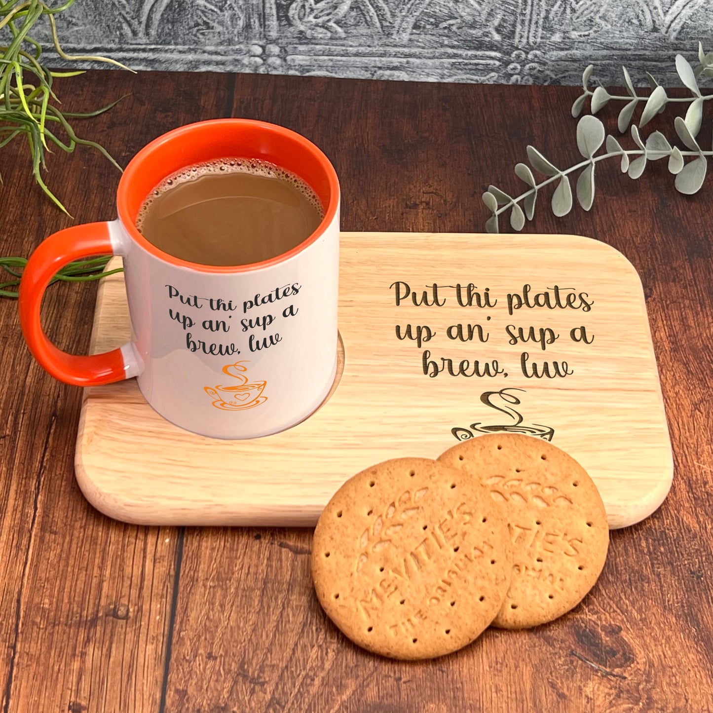 A wooden tray with a mug and two cookies on it, placed on a wooden surface.