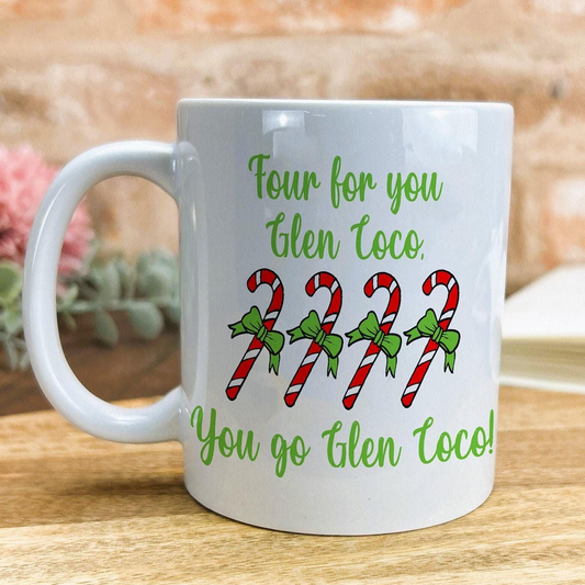 A white mug with a humorous text and candy cane design printed on it.