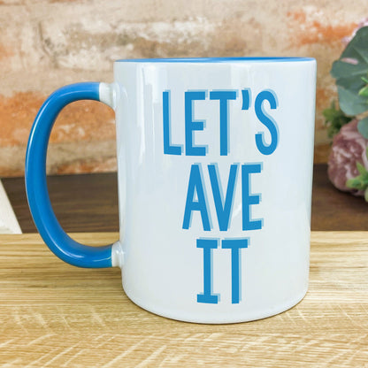 a blue and white coffee mug sitting on top of a wooden table