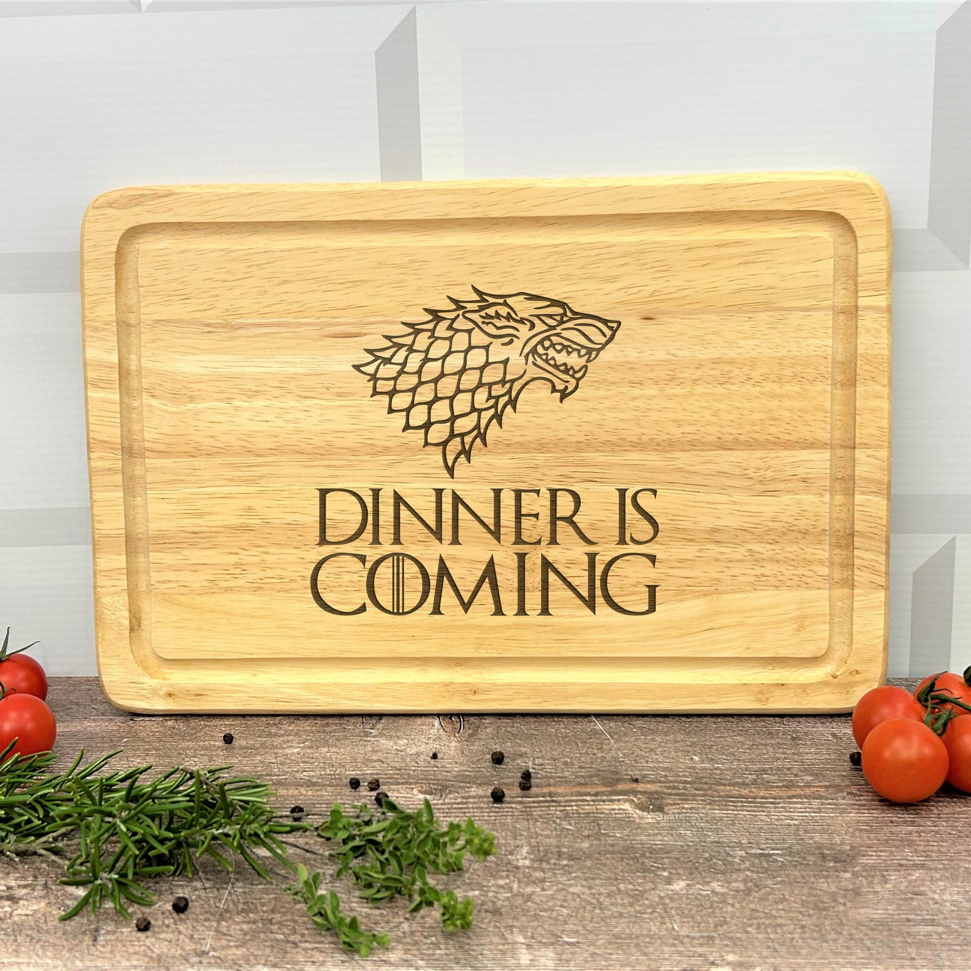 a wooden cutting board with a game of throne logo