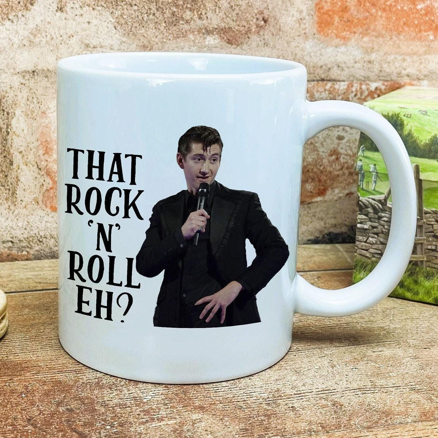 a mug with a picture of a man holding a microphone