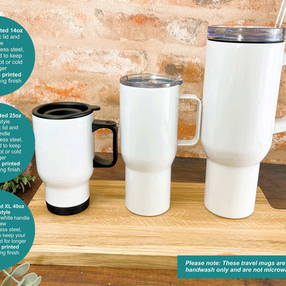 a couple of white coffee cups sitting on top of a wooden table