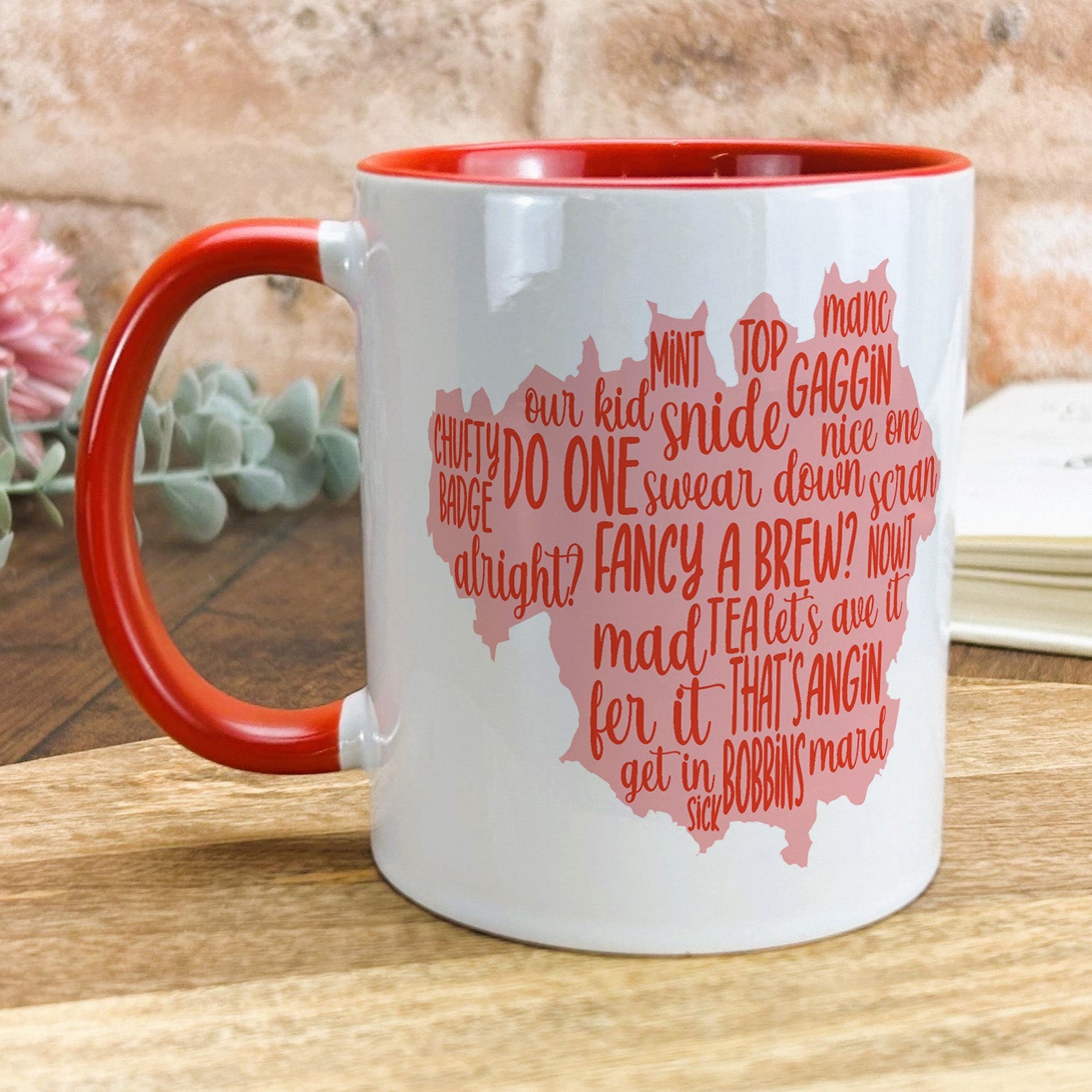 a red and white coffee mug with words on it
