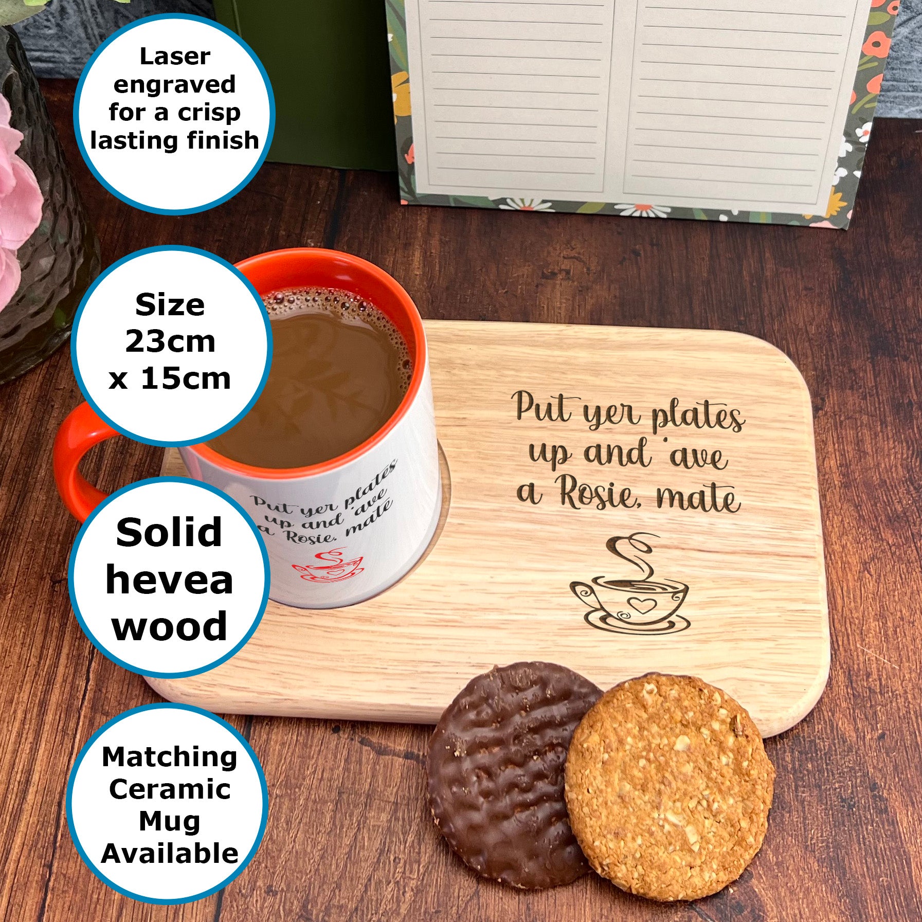 A wooden mug coaster with a message about putting plates up and a mug, accompanied by a cup of coffee and two cookies on a wooden tray.