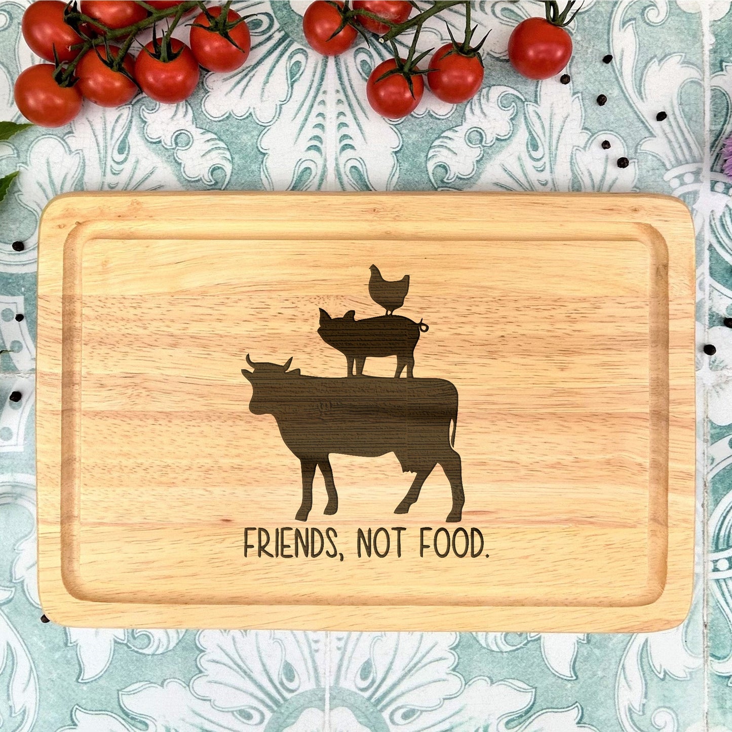 a cutting board with a picture of a cow and a cat on it