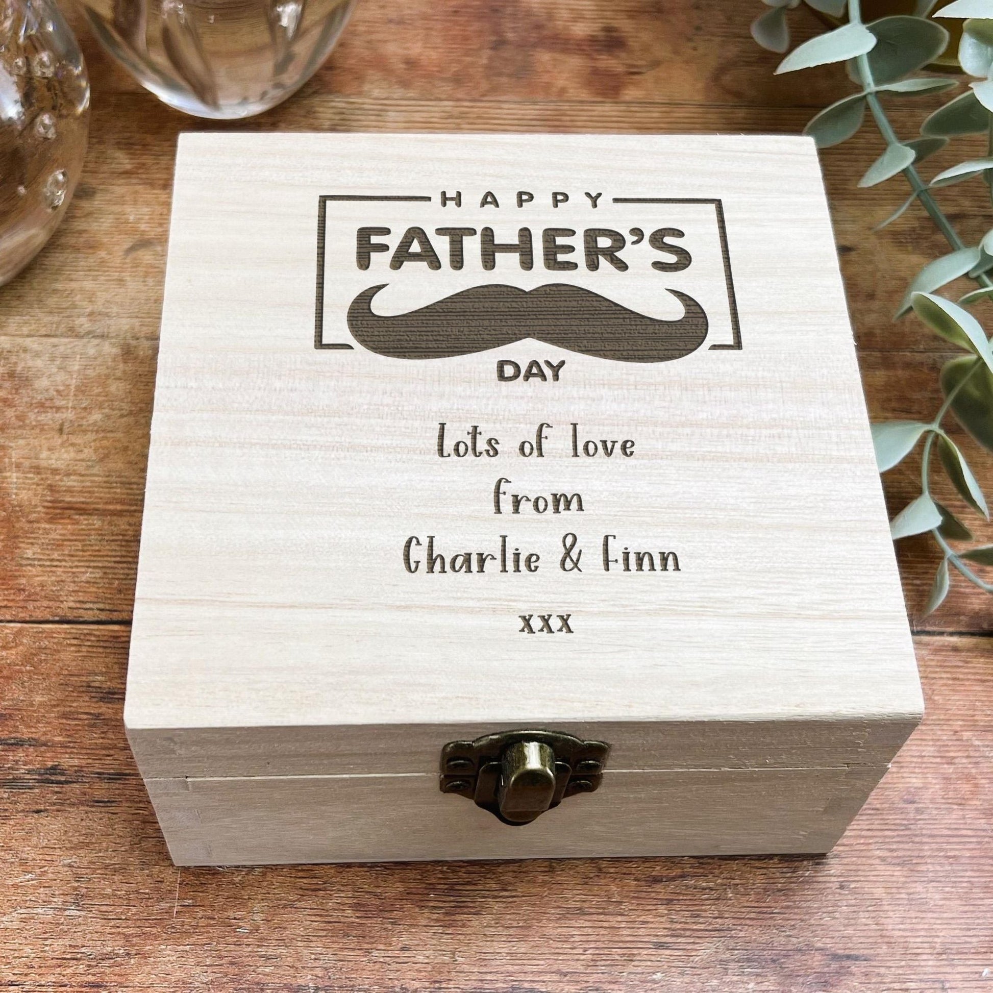 a wooden box with a picture of a mustache on it