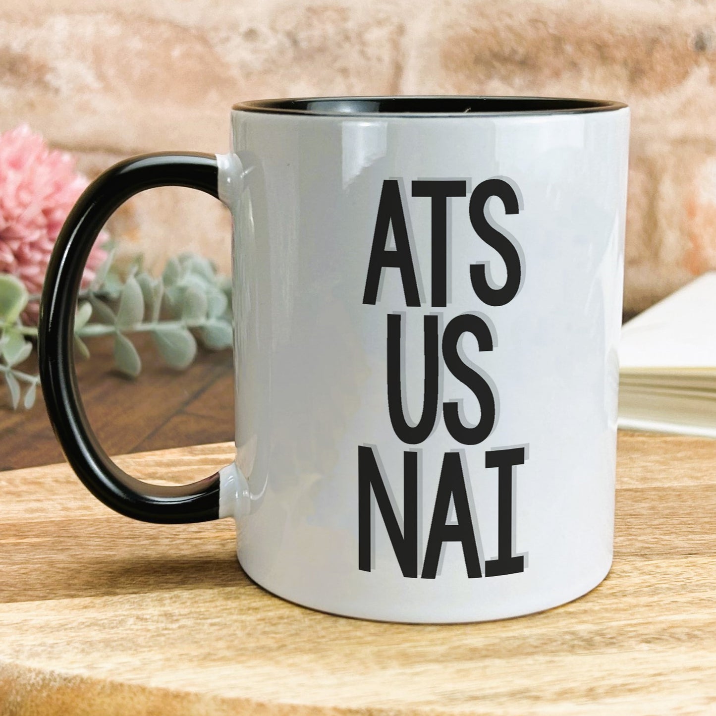 a black and white coffee mug with the words ats us nai on it