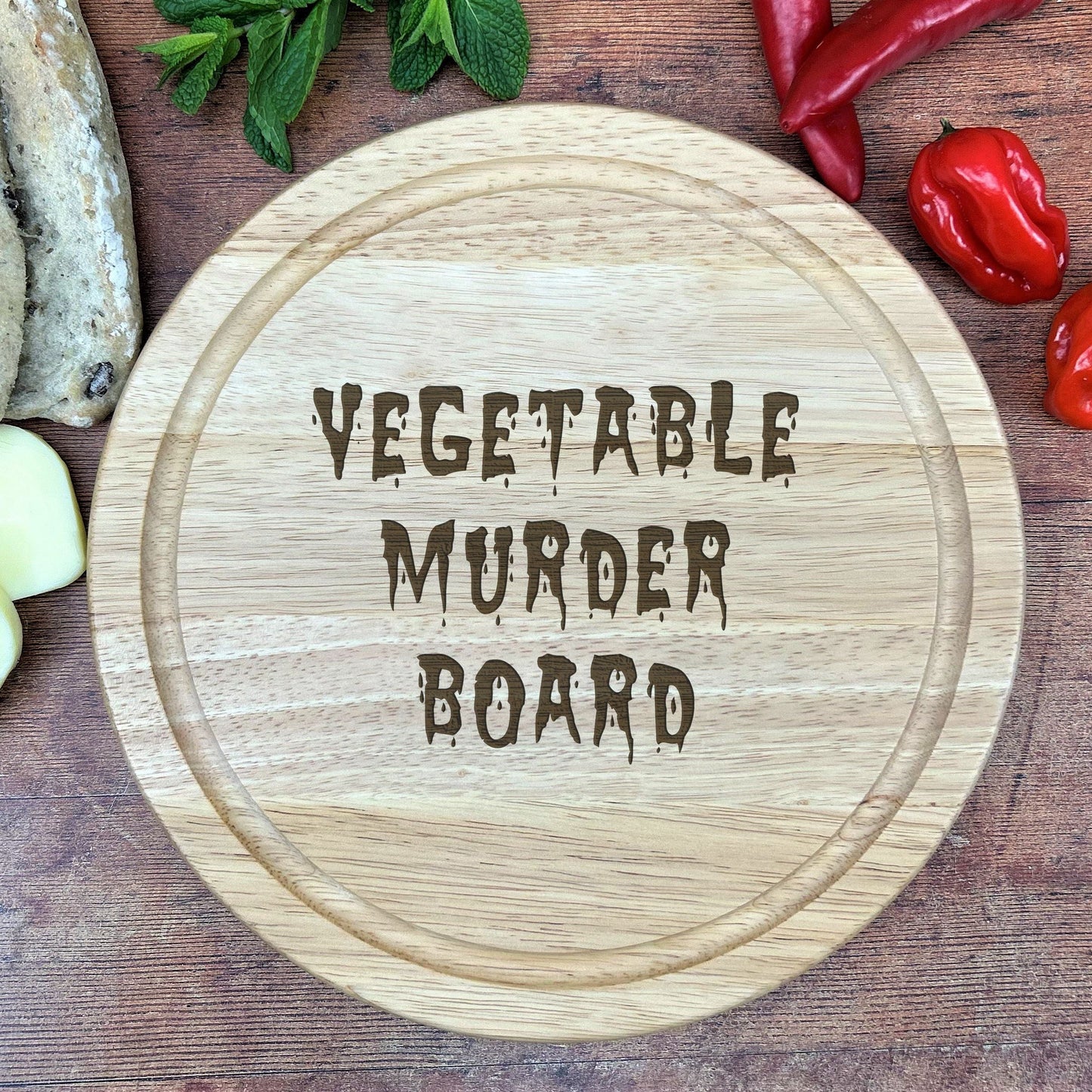a cutting board with the words vegetable murder board on it