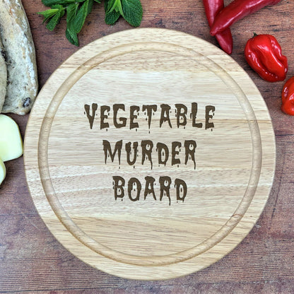 a cutting board with the words vegetable murder board on it