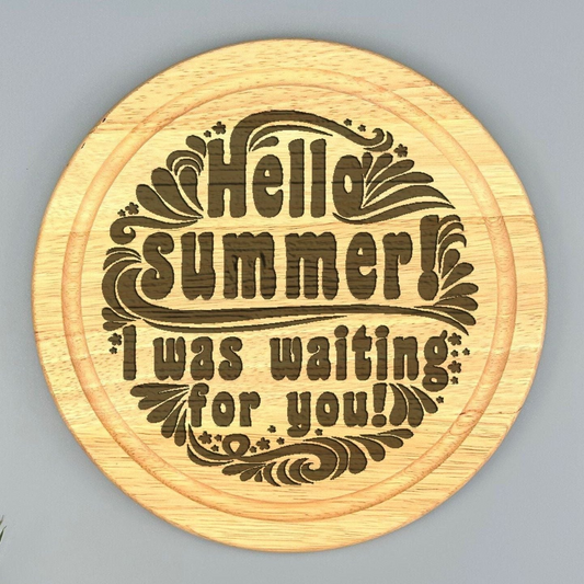 A wooden coaster with a decorative design featuring the text "Hello summer! I was waiting for you!"
