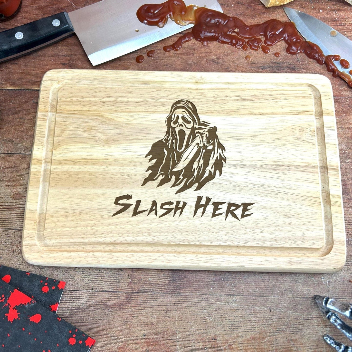 a wooden cutting board with a picture of a ghost on it
