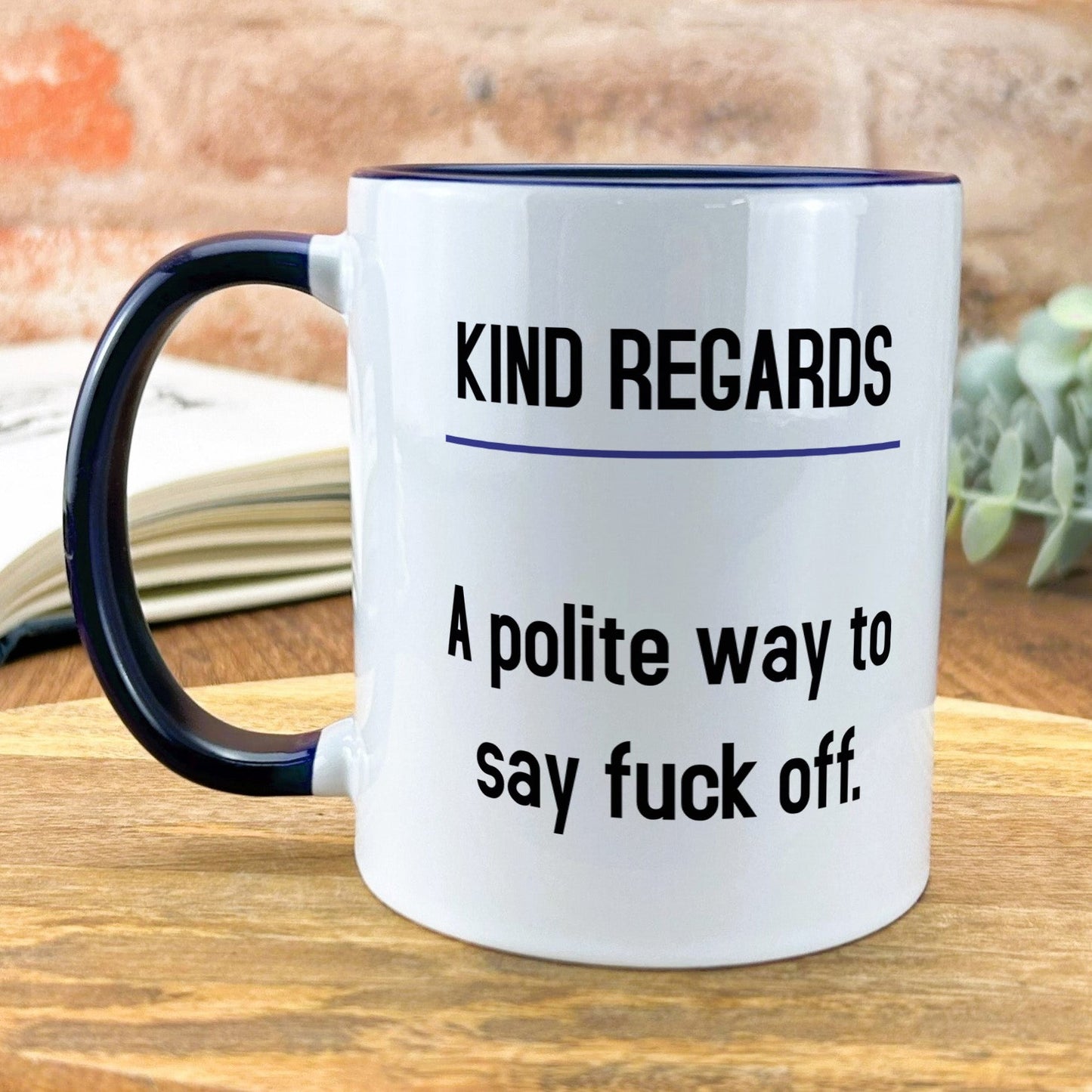 a white and black coffee mug sitting on top of a wooden table