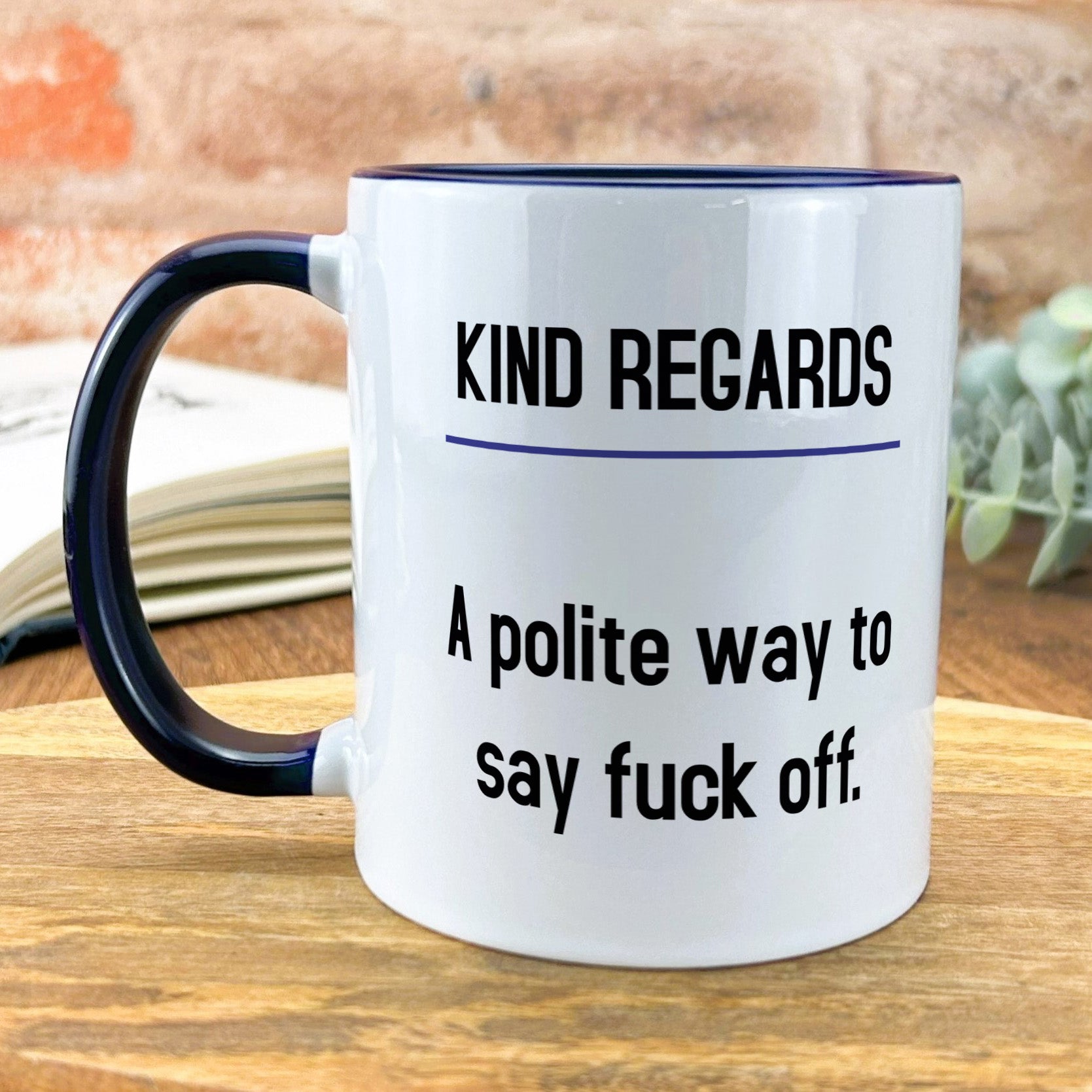 a white and black coffee mug sitting on top of a wooden table