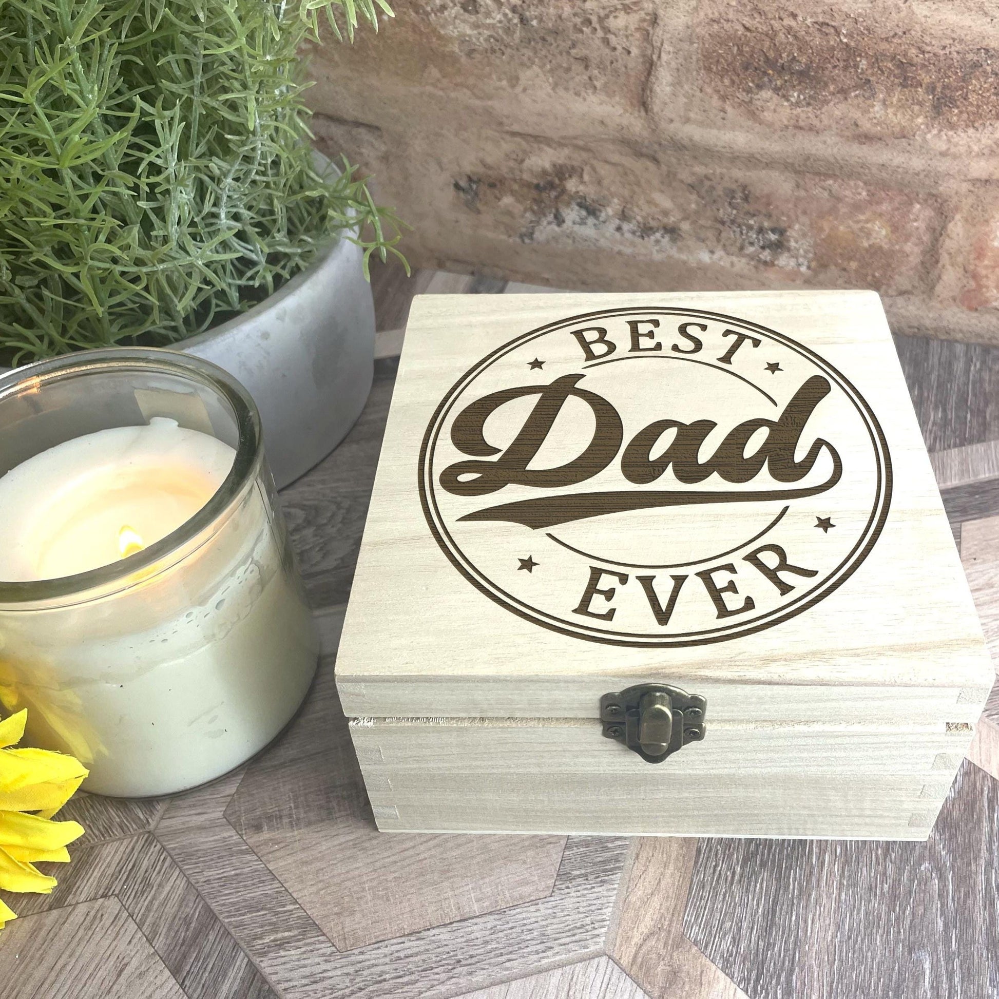 a wooden box sitting next to a vase of flowers