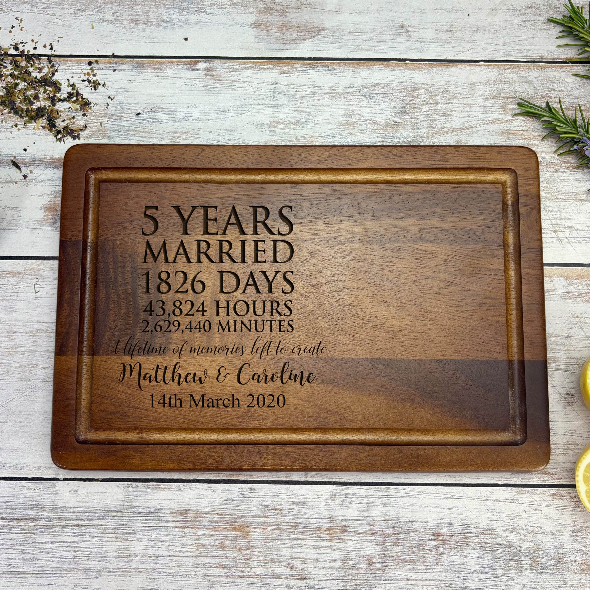 a personalized cutting board with a couple's names on it