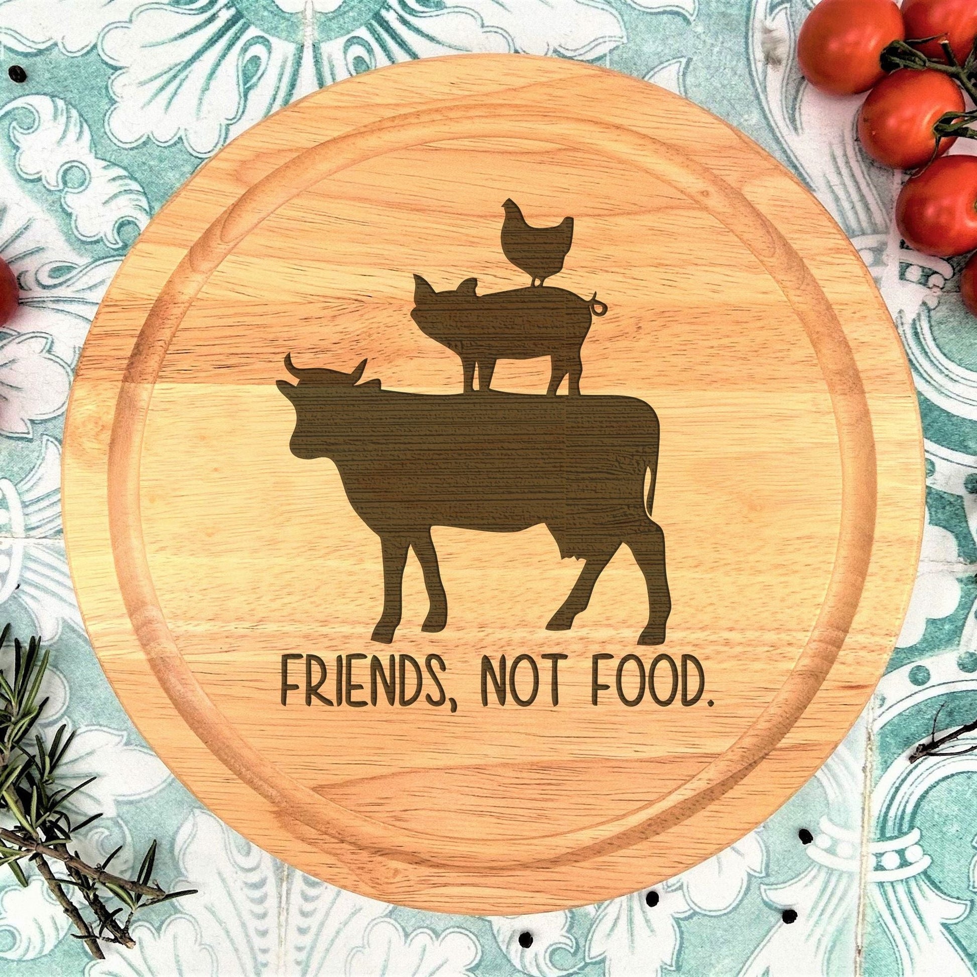 a cutting board with a picture of a cow and two cats on it