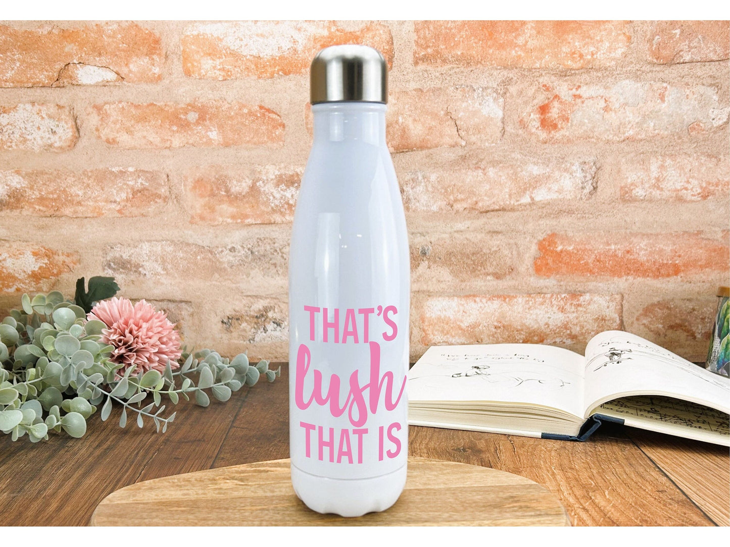 a white water bottle sitting on top of a wooden table