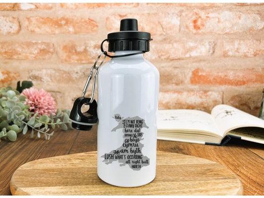 a water bottle with a keychain is sitting on a table