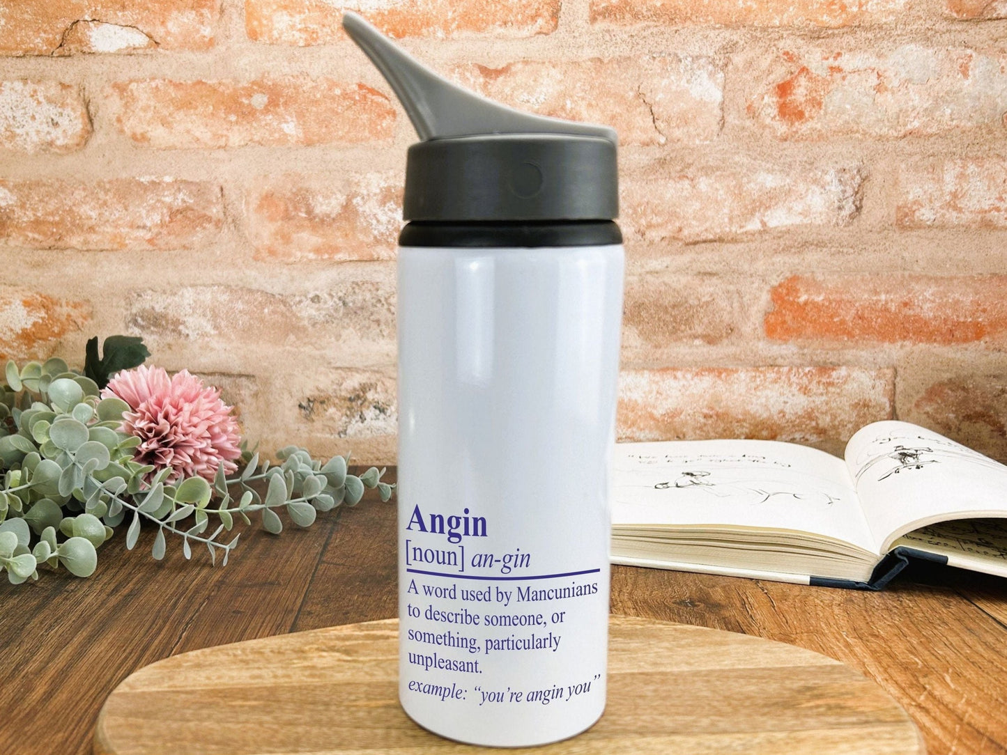 a white water bottle sitting on top of a wooden table