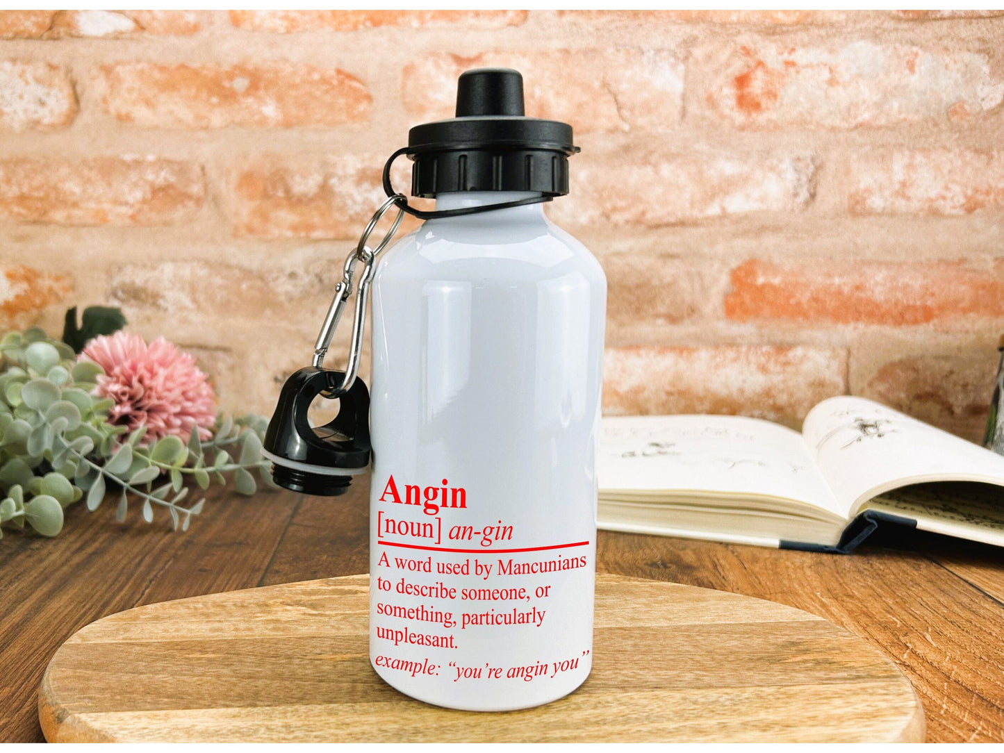 a white water bottle sitting on top of a wooden table