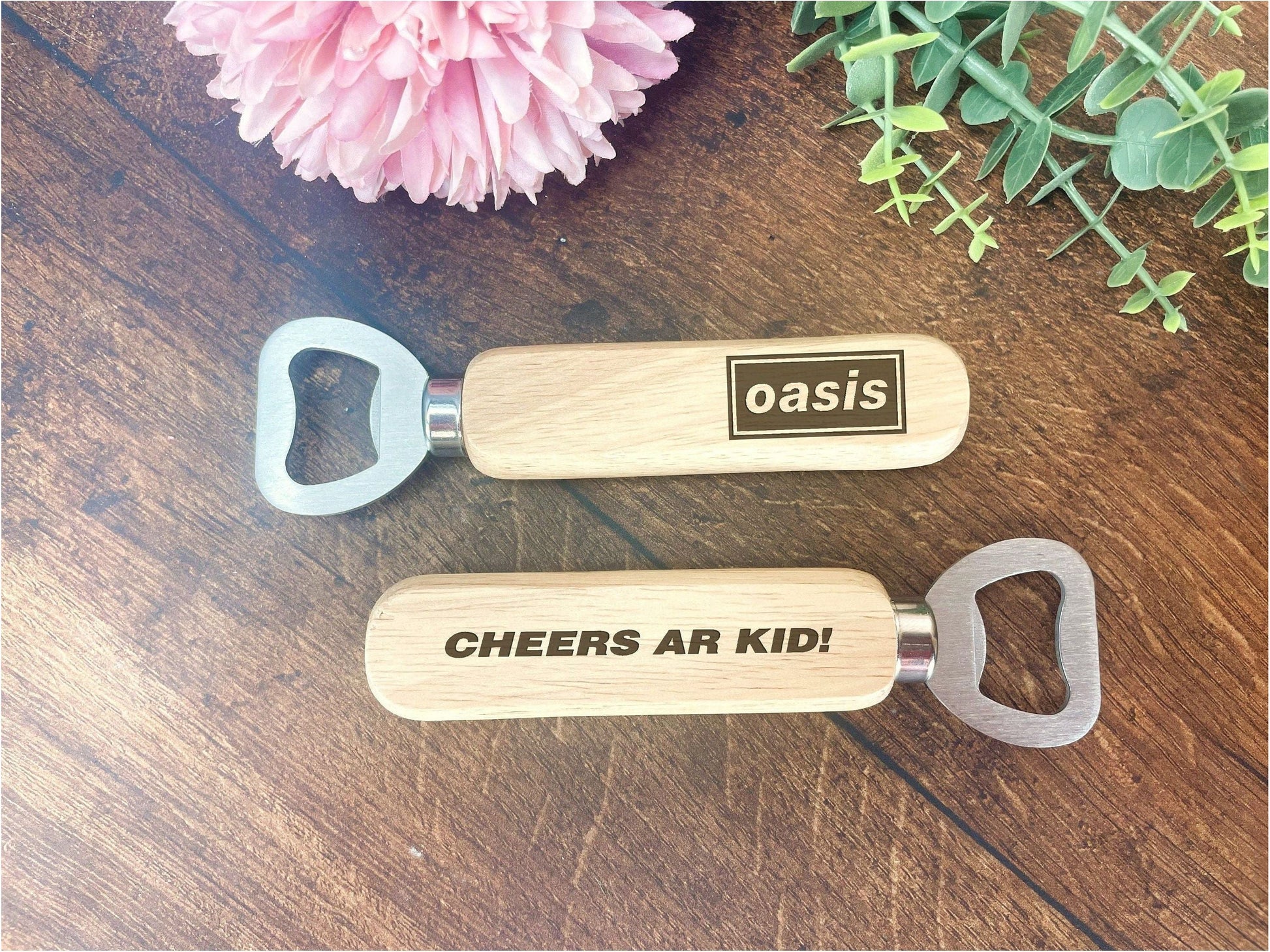 a couple of bottle openers sitting on top of a wooden table