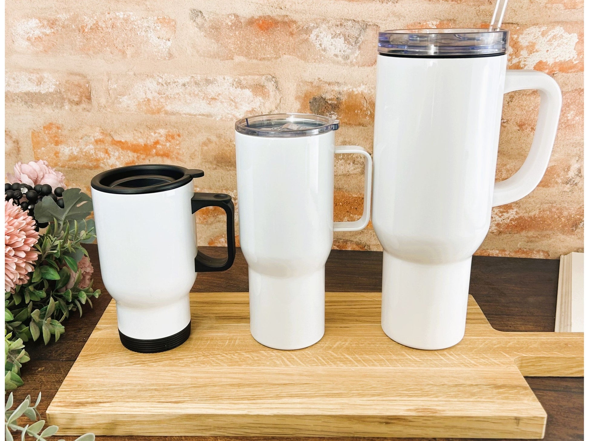 a couple of white cups sitting on top of a wooden table