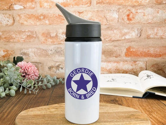 a white travel mug with a purple star on it