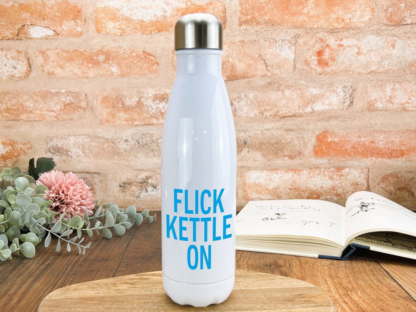 a white water bottle sitting on top of a wooden table