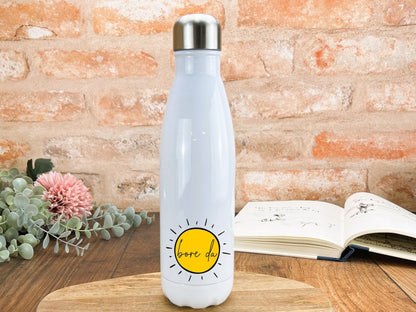 a white water bottle sitting on top of a wooden table