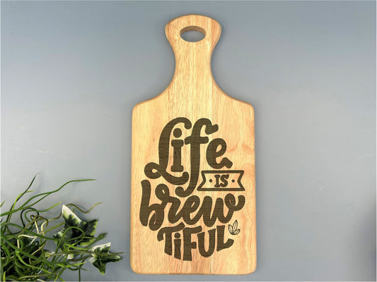 a cutting board with the words life is a brew of life on it