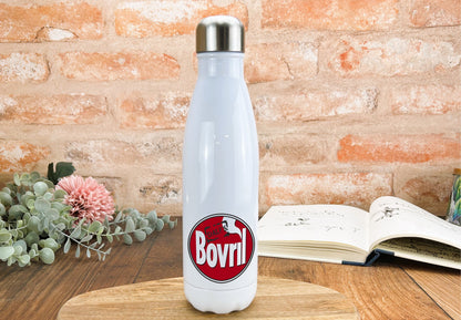 a white bottle sitting on top of a wooden table