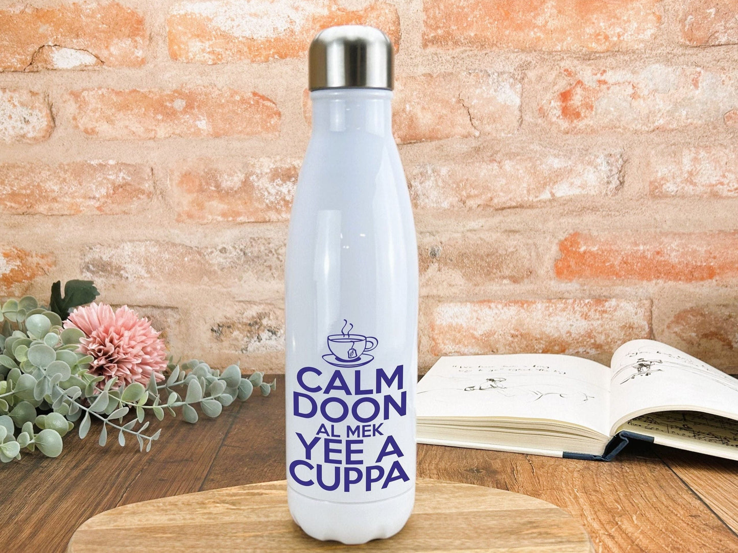 a white water bottle sitting on top of a wooden table