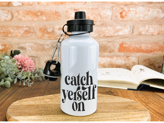 a white water bottle sitting on top of a wooden table