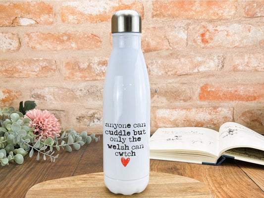 a white water bottle sitting on top of a wooden table