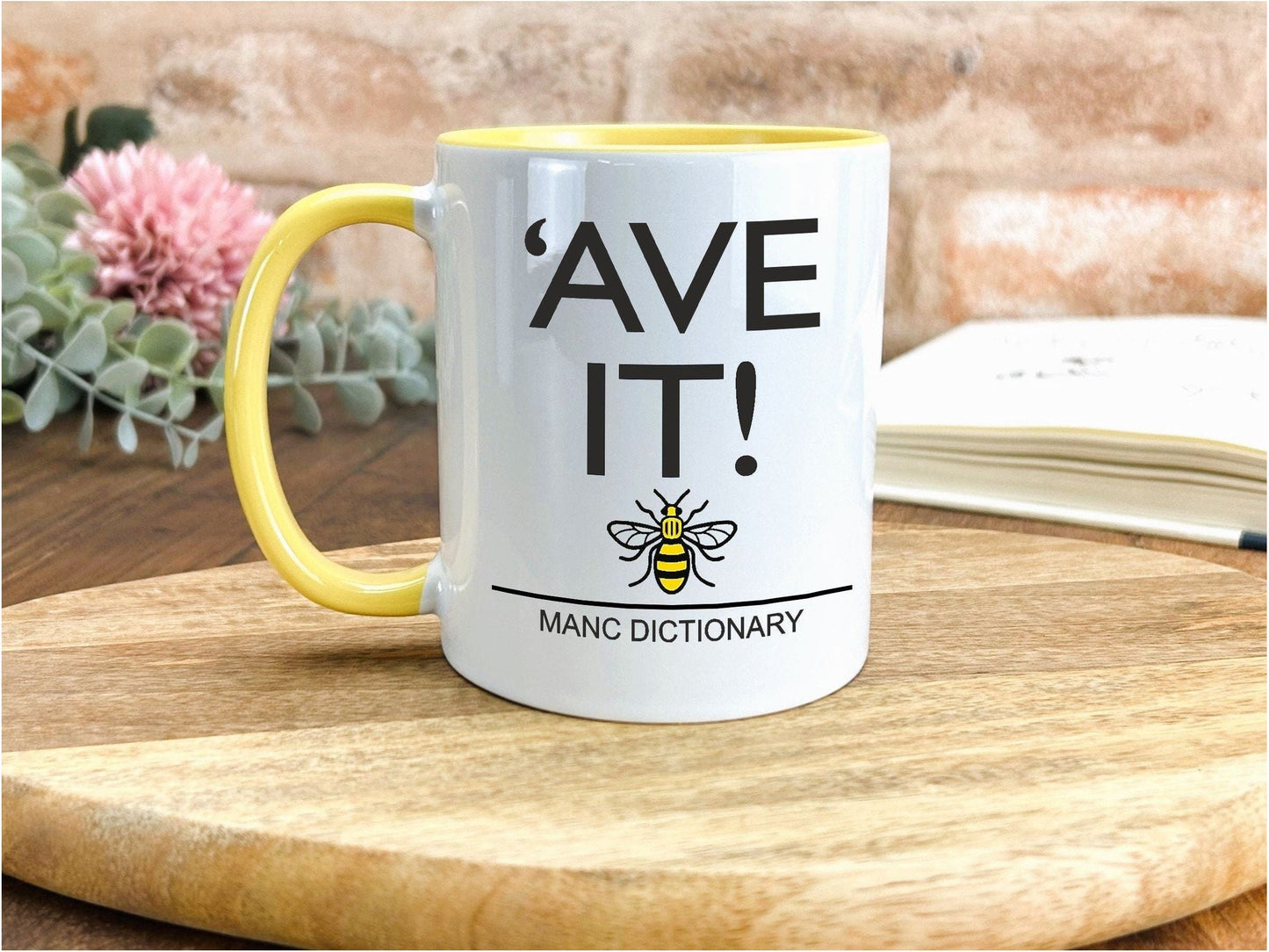 a yellow and white coffee mug sitting on top of a wooden table