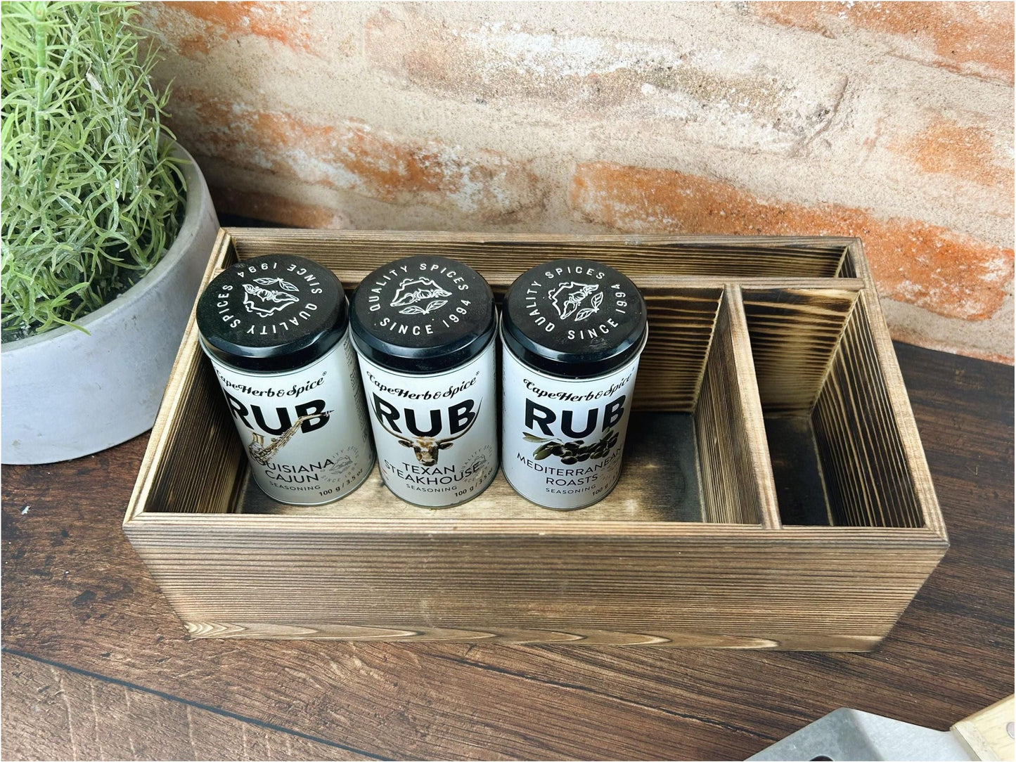 three cups of coffee sit in a wooden box