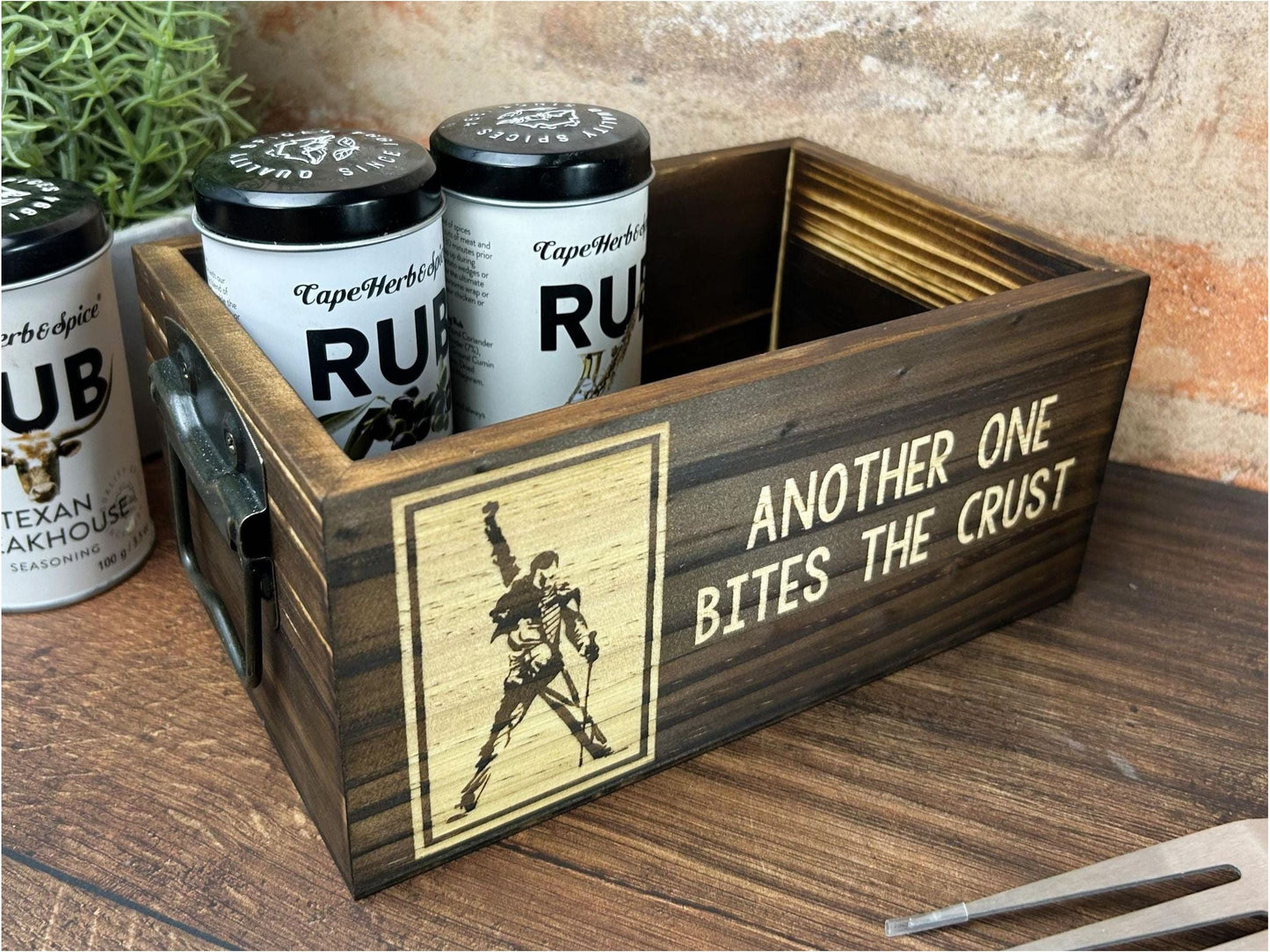 a wooden box with three cans of beer in it