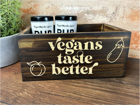 a wooden box with a sign that says vegans taste better