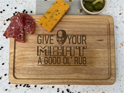 a cutting board with cheese, olives, and meat on it