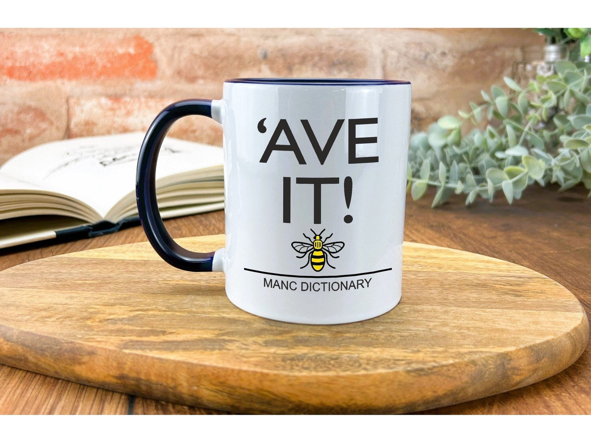 a white and black coffee mug sitting on top of a wooden table