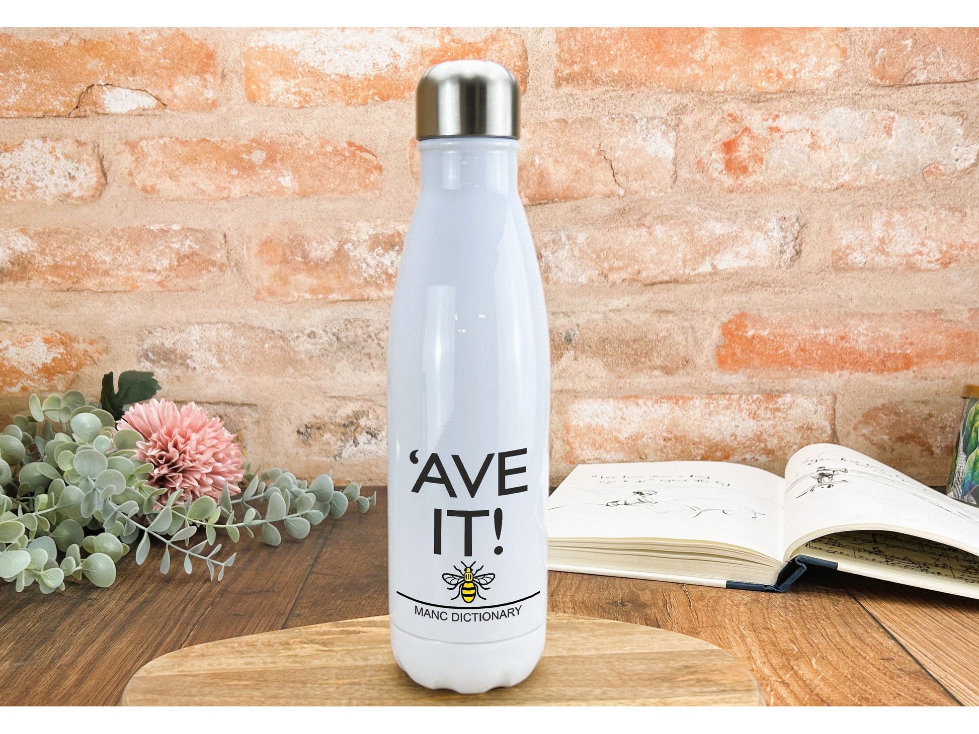 a white water bottle sitting on top of a wooden table