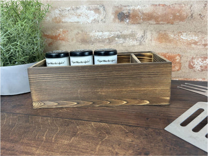 a wooden box filled with three jars of coffee