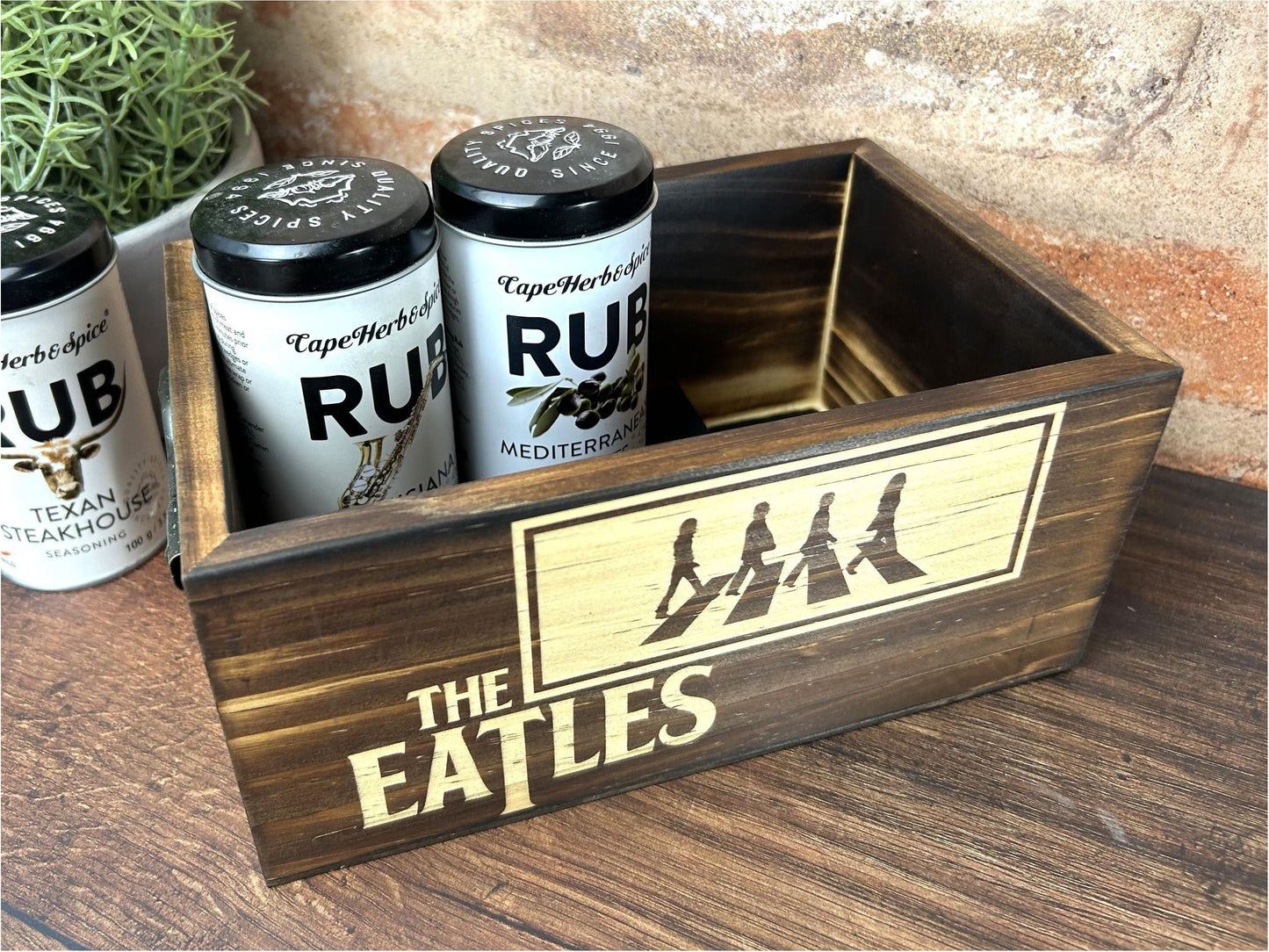 a wooden box filled with three cans of beer